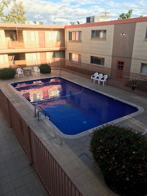 a large swimming pool in front of a building