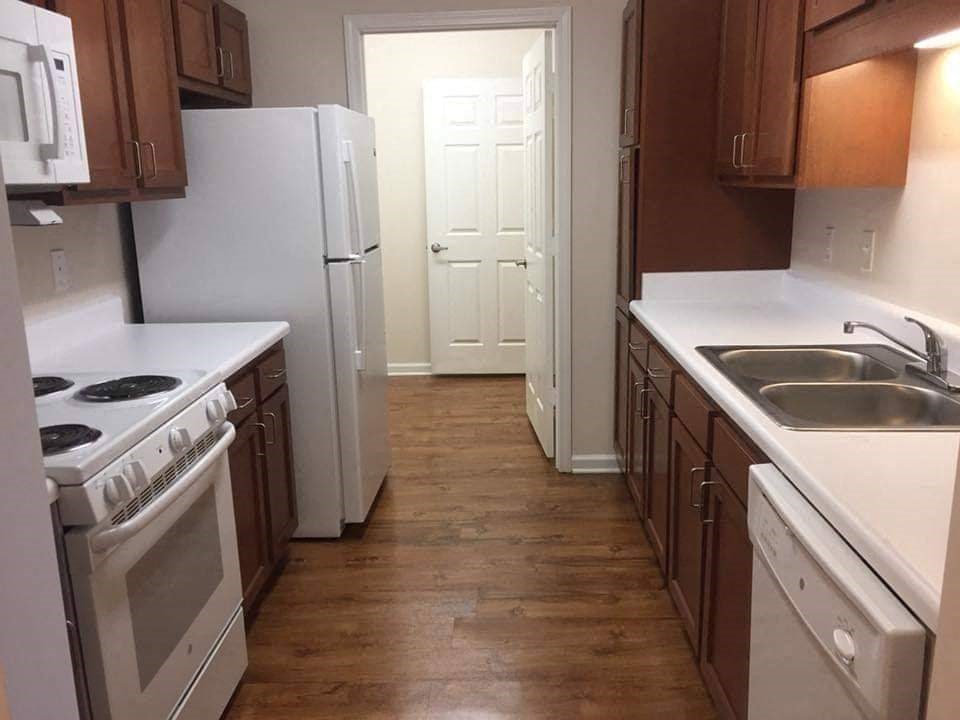 a kitchen with a stove and a refrigerator and a sink
