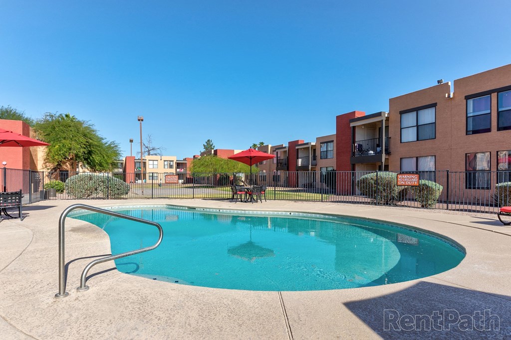 a swimming pool with a building in the background