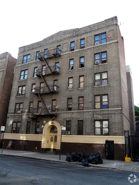 a building with a fire escape on the side of a street