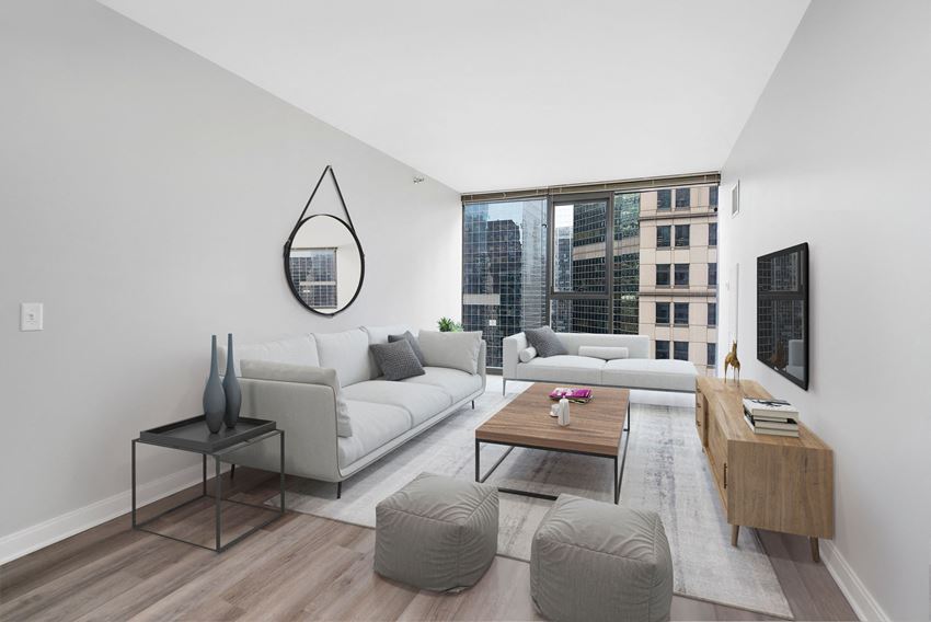 One bedroom unit living roon with two couches, coffee table, and tv with tv stand - Photo Gallery