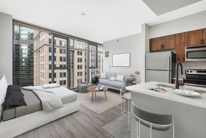 Studio unit with queen size bed, two person couch, table, and kitchen - Photo Gallery