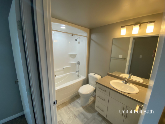 a small bathroom with a toilet sink and tub and a mirror