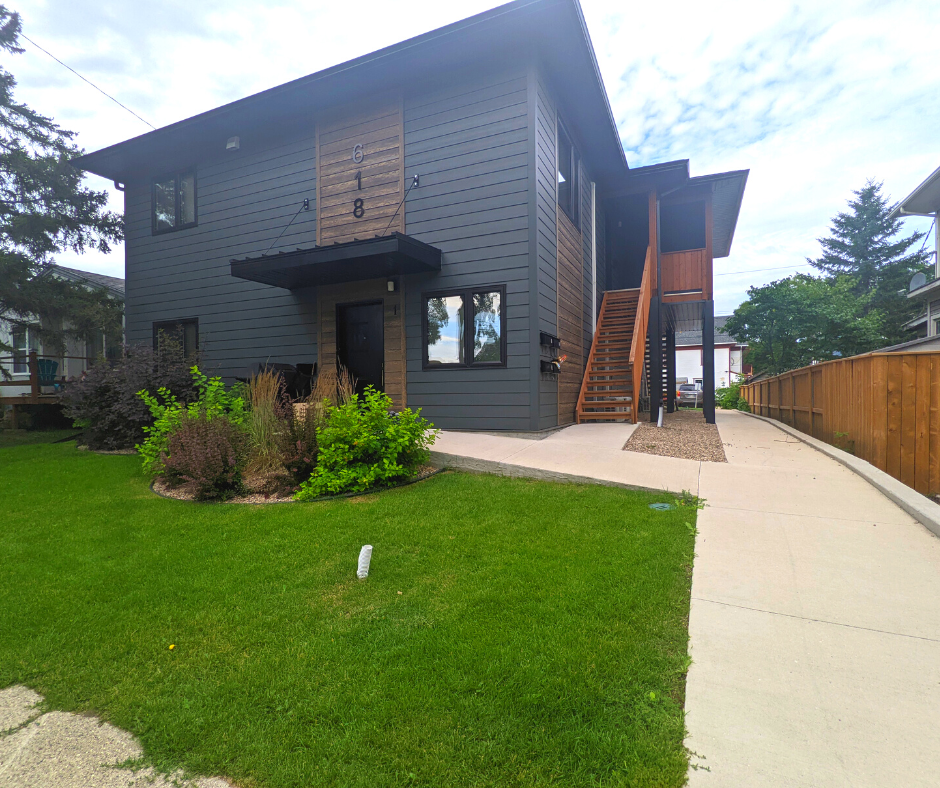 a large house with a sidewalk in front of it