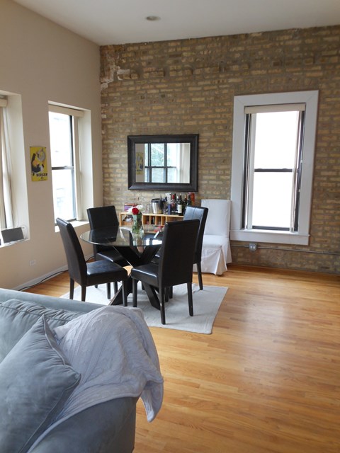 a view of a living room and dining room with a couch and a table