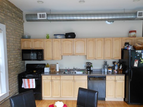 a small kitchen with black appliances and wooden cabinets