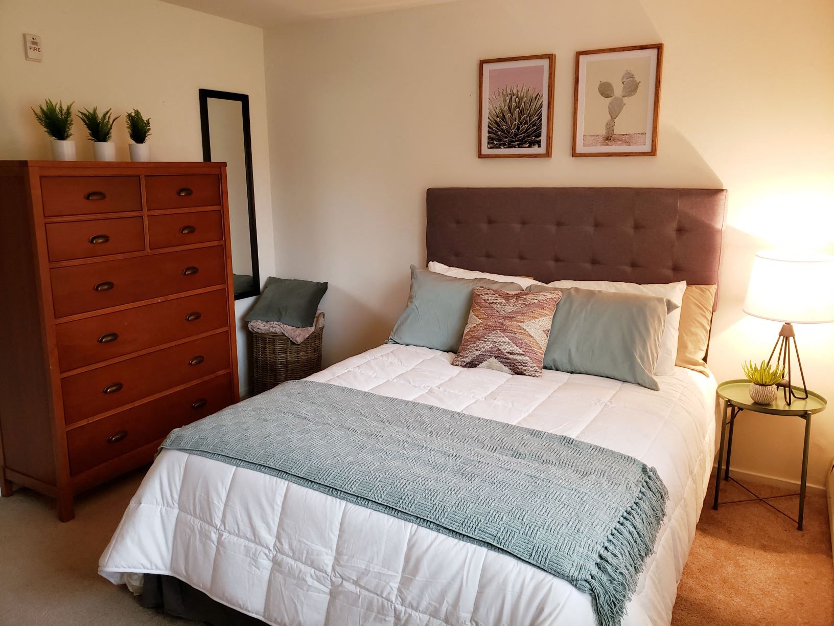 a bedroom with a bed and a dresser