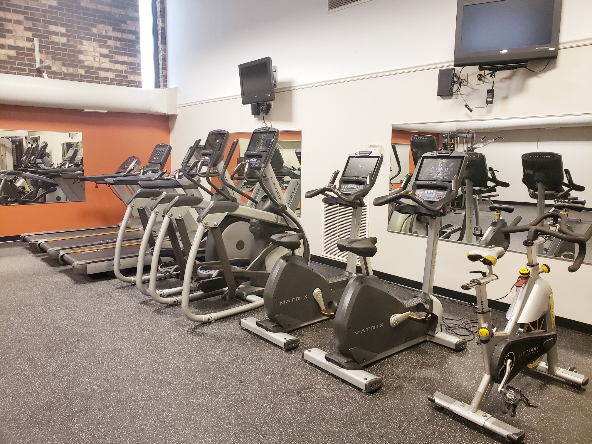 a row of exercise bikes in a gym