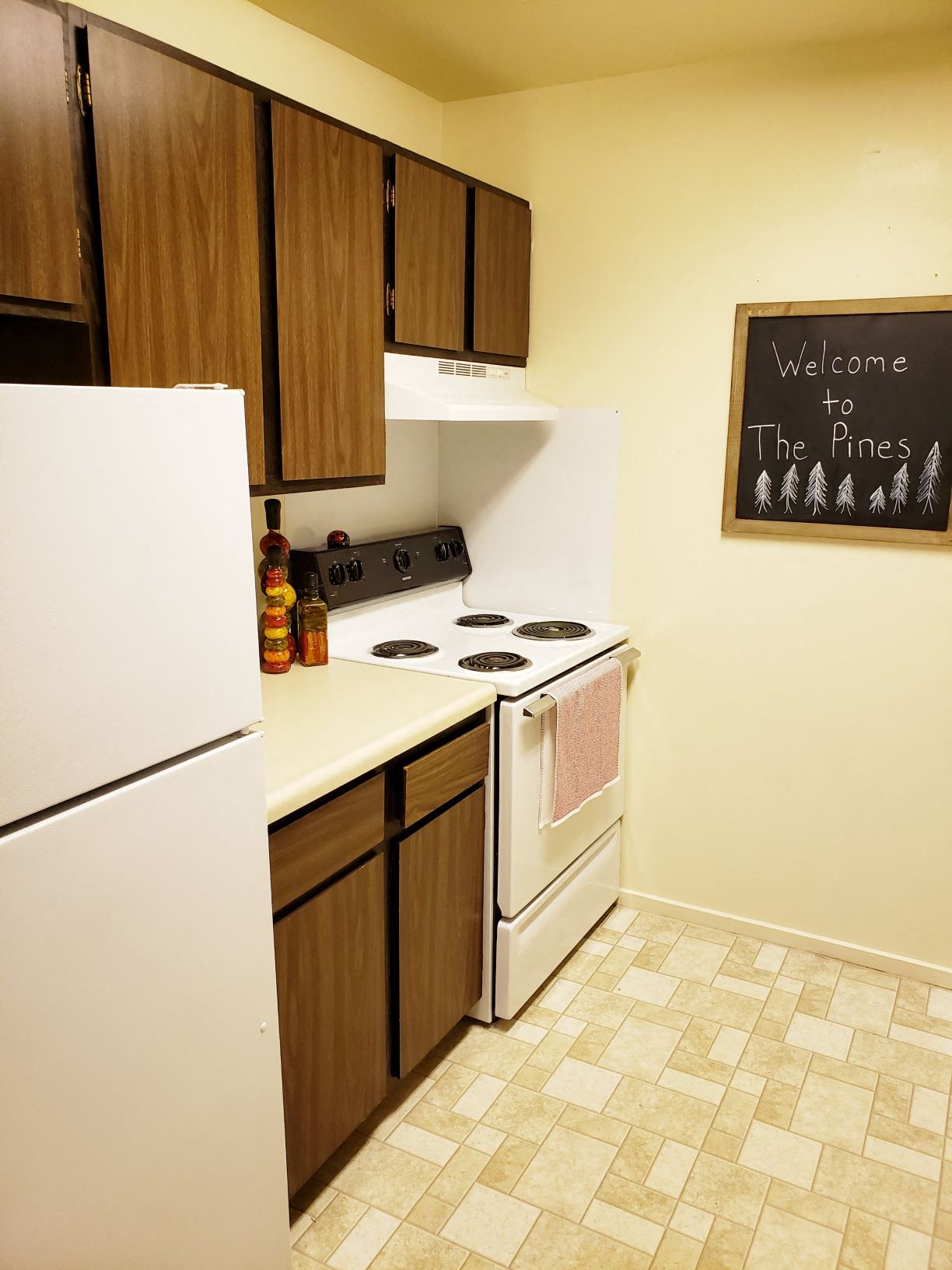 a kitchen with a white stove and a refrigerator