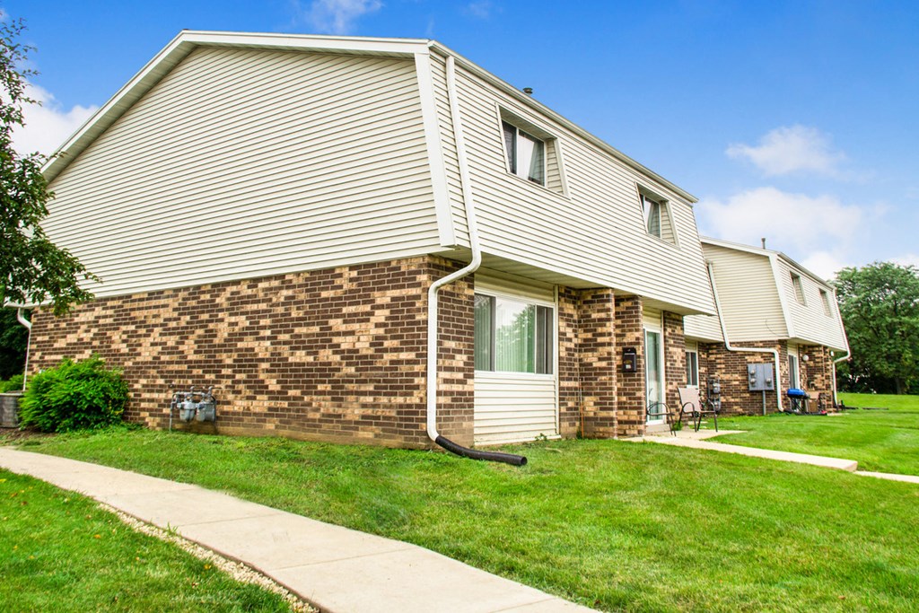 a white house with a sidewalk in front of it