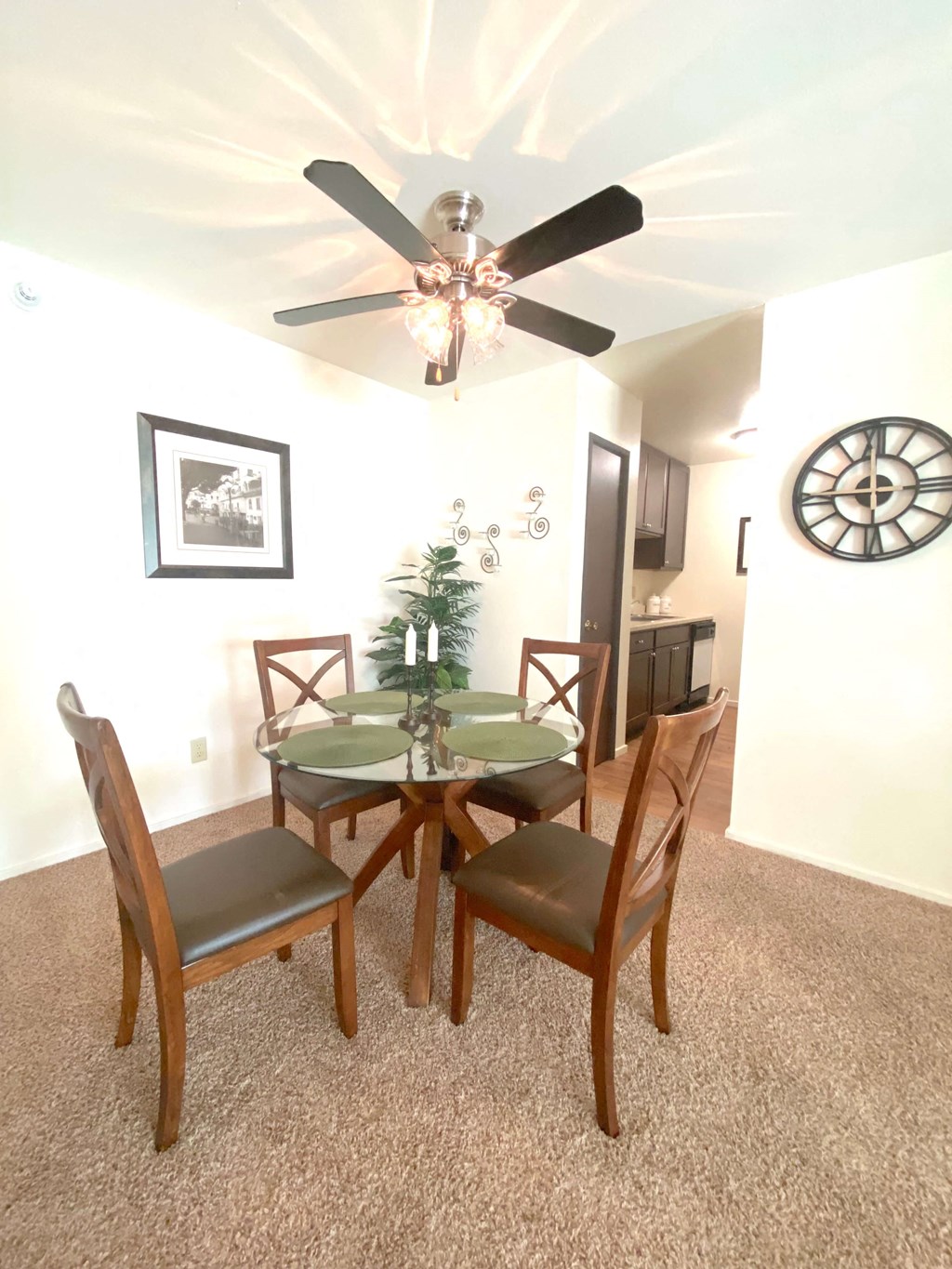 a dining room with a table and a ceiling fan