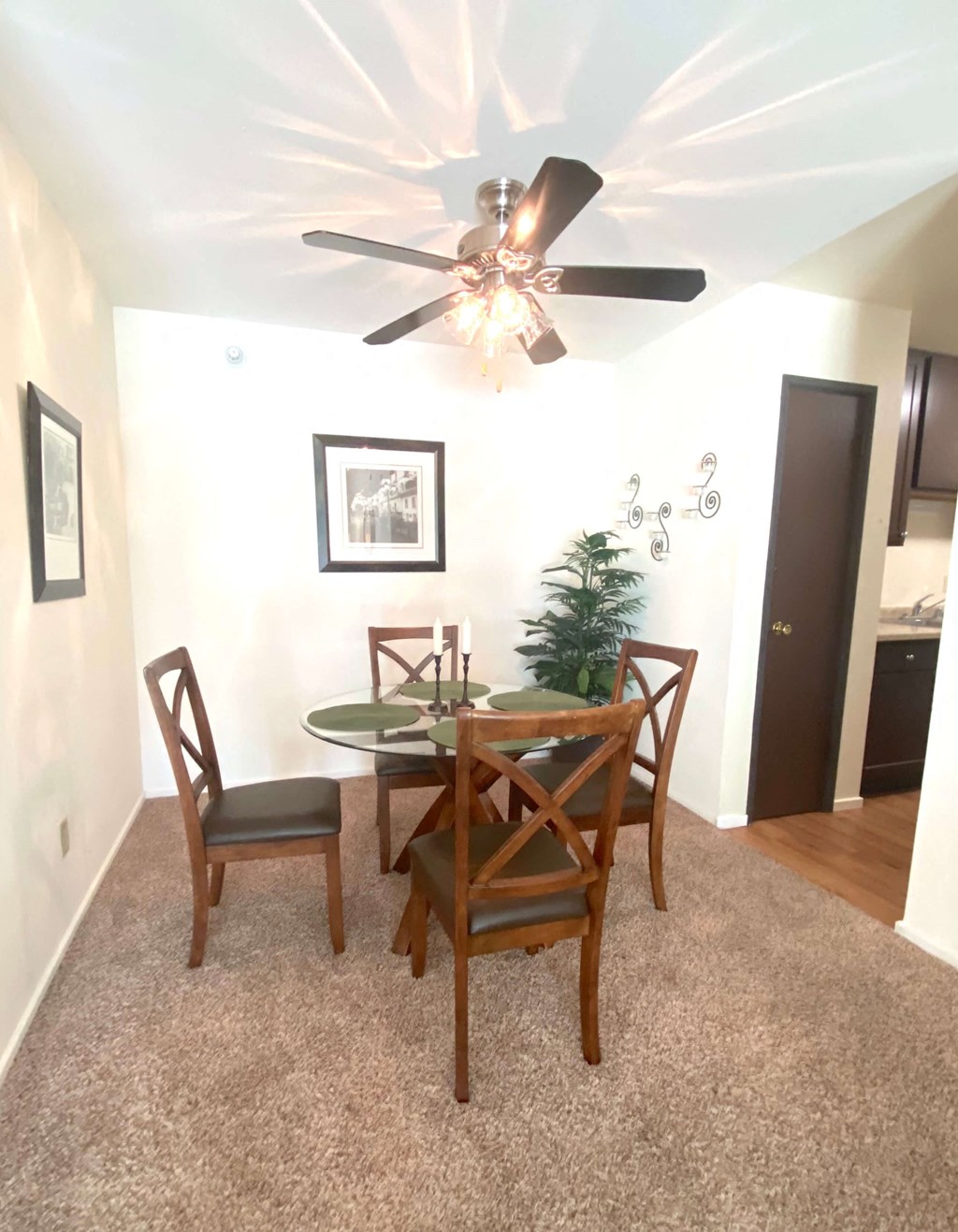 a dining room with a table and a ceiling fan