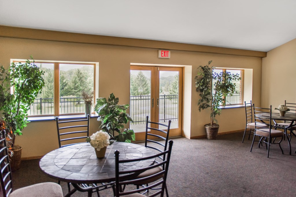 a dining room with tables and chairs and a patio