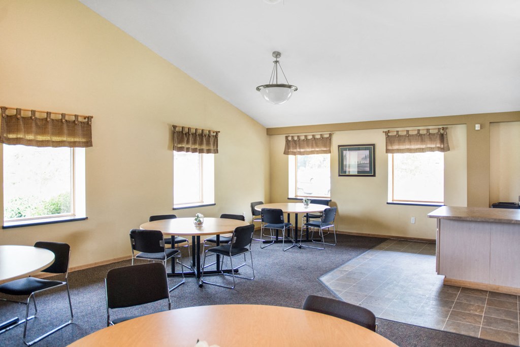 a dining room with tables and chairs and a counter