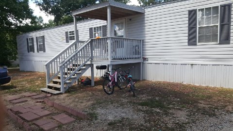 A bicycle is parked in front of a house.