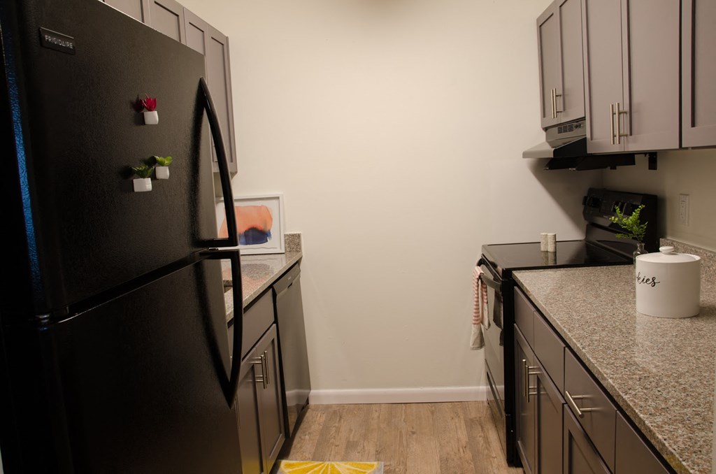 a kitchen with black appliances and granite counter tops