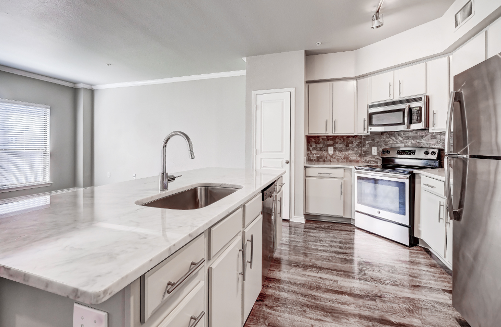 Kitchen with pantry, garbage disposal, and modern track lighting