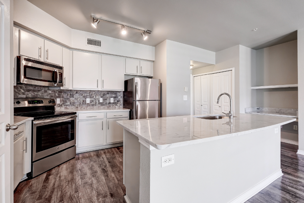 Kitchen with stainless steel appliances and built-in work desk