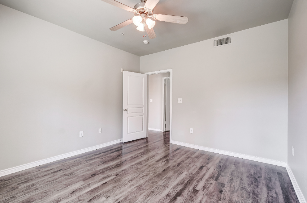 Bedroom with wood-style flooring, ceiling fan, and cable ready