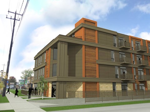 A modern building with orange accents and people walking on the sidewalk.