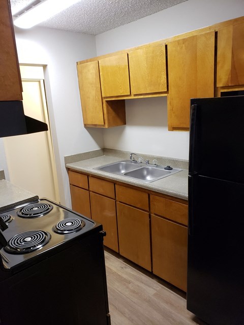 an empty kitchen with a stove and a sink