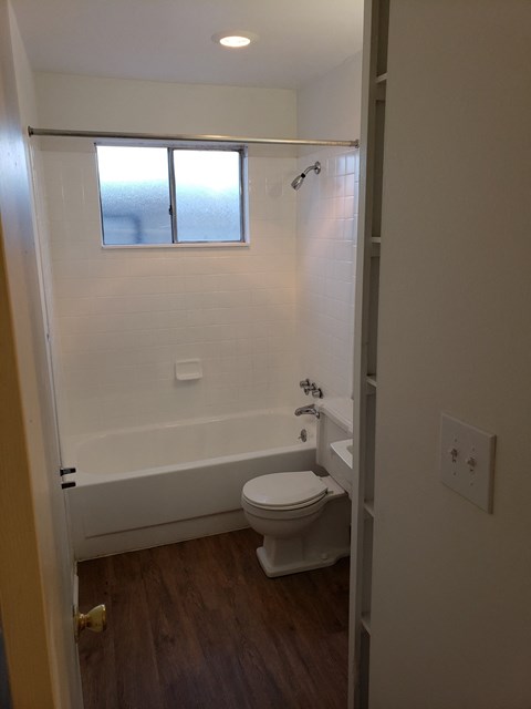a small bathroom with a toilet and a window