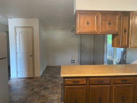 an empty kitchen with a counter top and cabinets