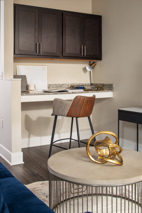 a kitchen with a bar and a chair and a table