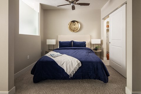 a bedroom with a bed and a ceiling fan
