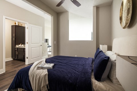 a bedroom with a large bed and a ceiling fan