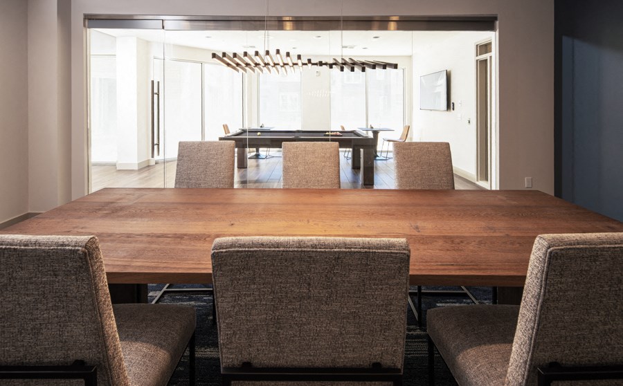 a dining room with a wooden table and chairs