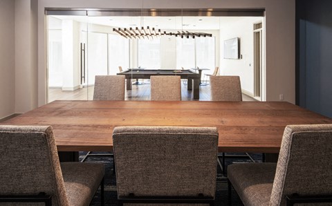 a dining room with a wooden table and chairs