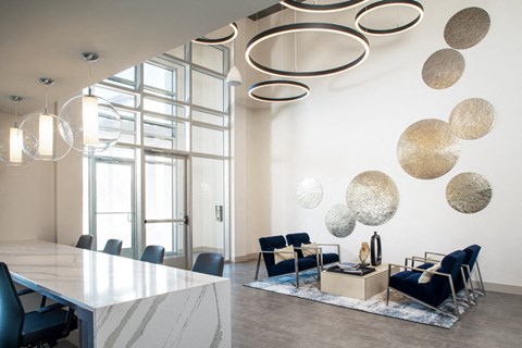 a conference room with blue chairs and a white table