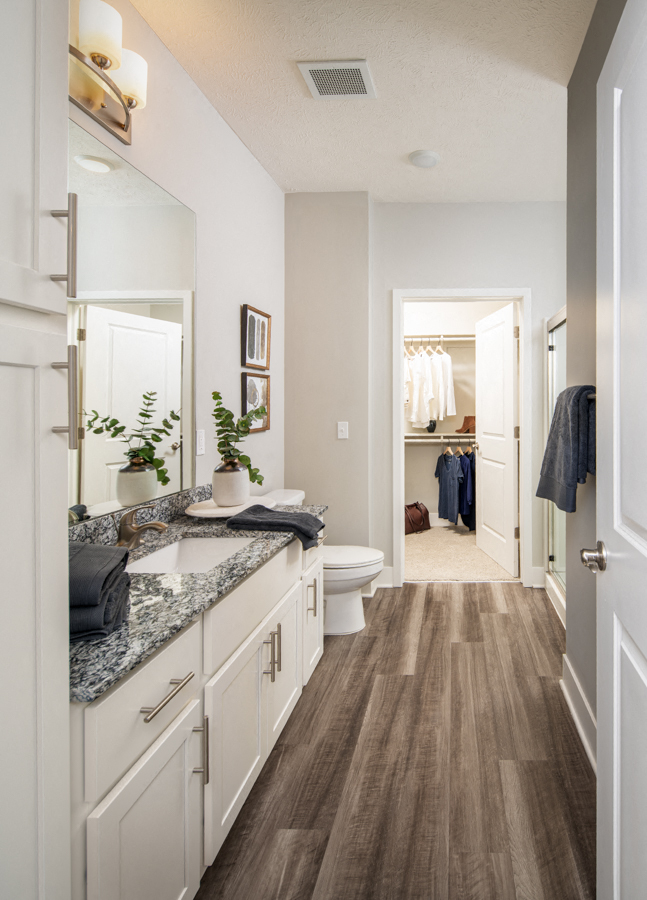 a bathroom with white cabinets and a sink and a toilet