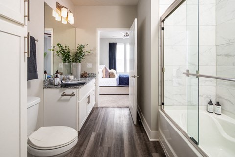 a bathroom with a shower and a toilet and a sink