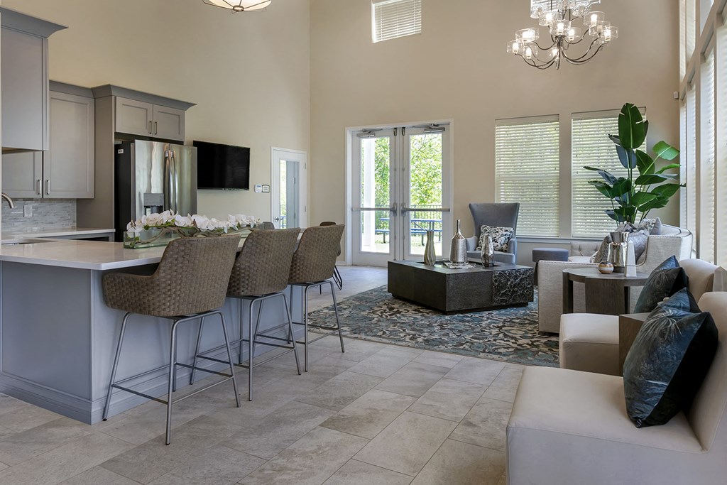 a kitchen with a bar and a living room
