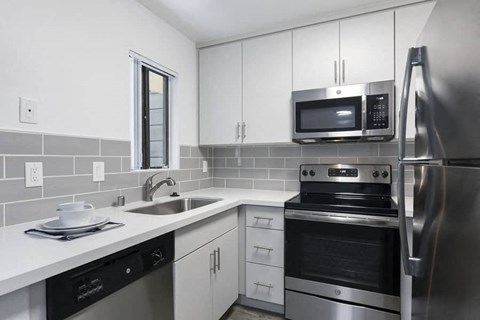 a kitchen with stainless steel appliances and a sink