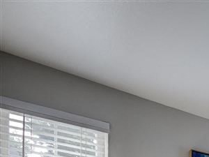 a bedroom with a bed and a table with lamps