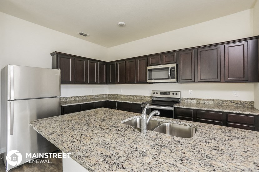 a kitchen with granite counter tops and stainless steel appliances
