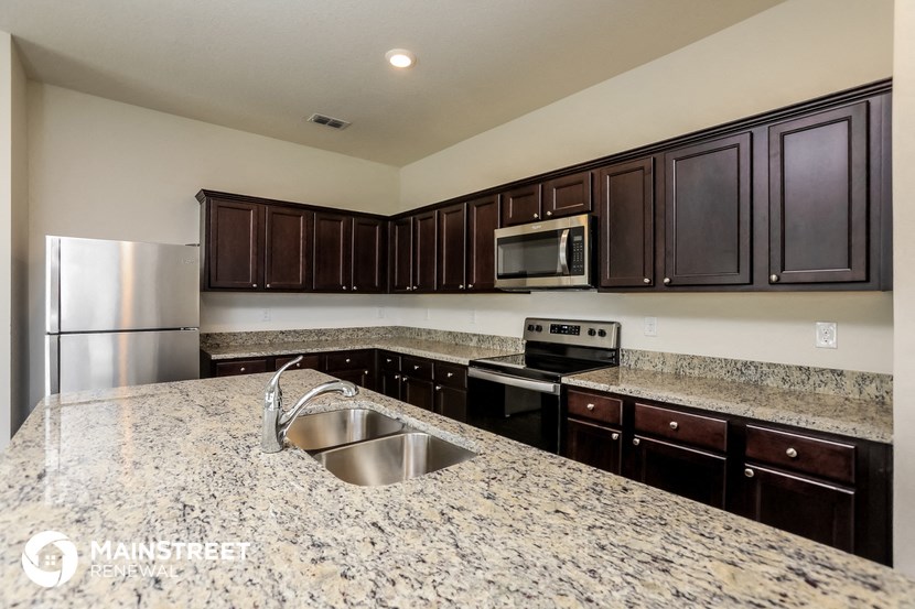 a kitchen with granite counter tops and stainless steel appliances