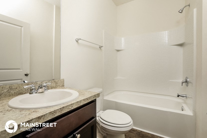 a bathroom with a sink toilet and a bath tub