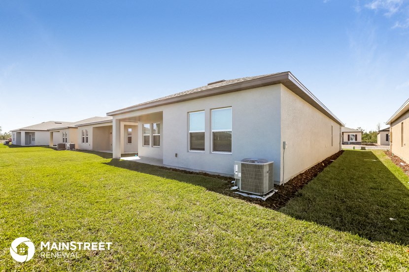 a row of houses with a grass yard and a blue sky