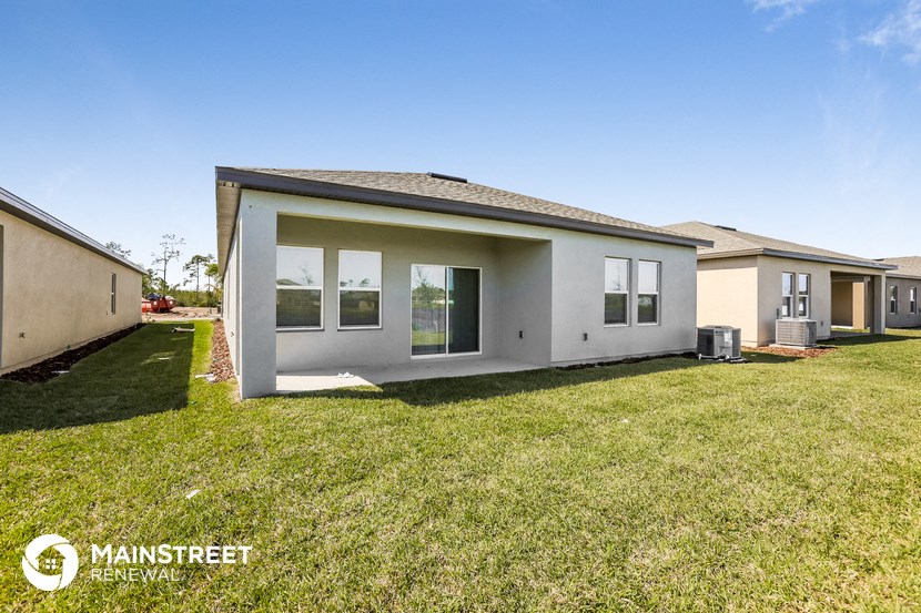 a small house with a yard and a lawn