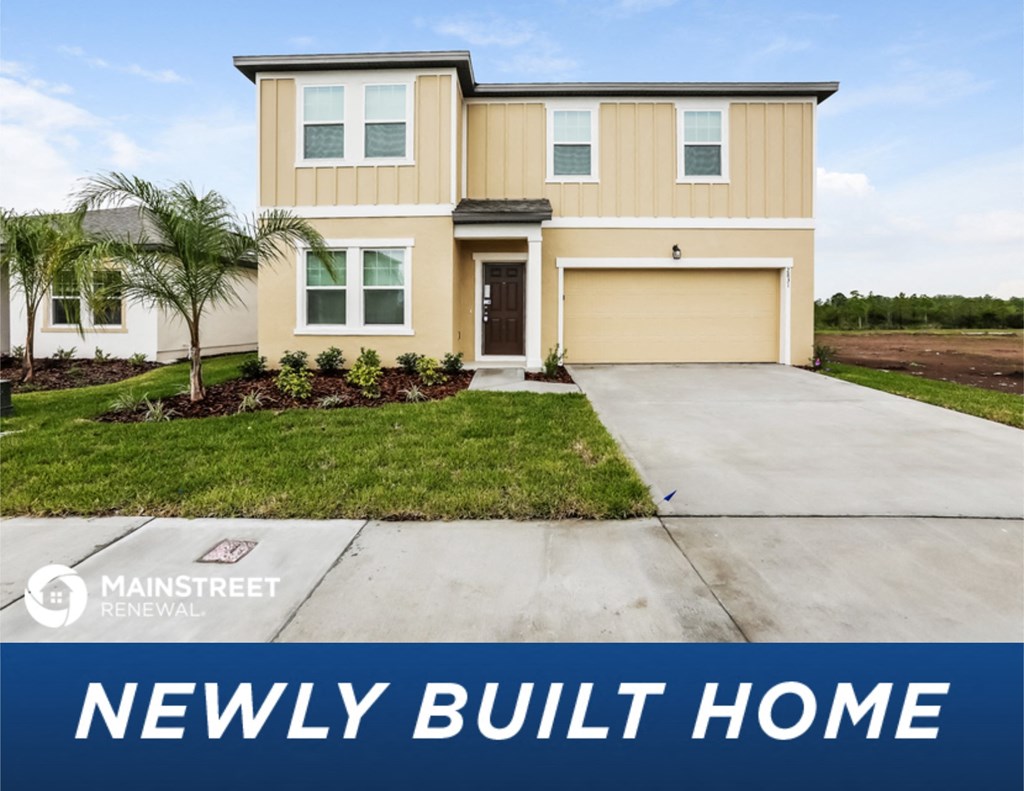 a new build home in front of a palm tree