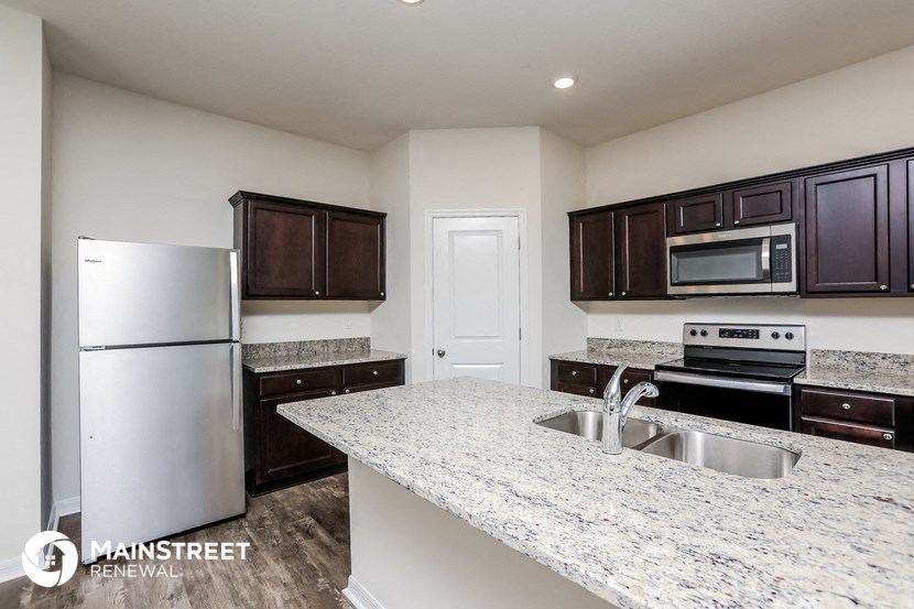 a kitchen with granite counter tops and stainless steel appliances
