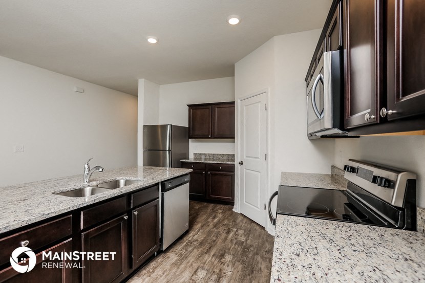 a kitchen with granite counter tops and stainless steel appliances