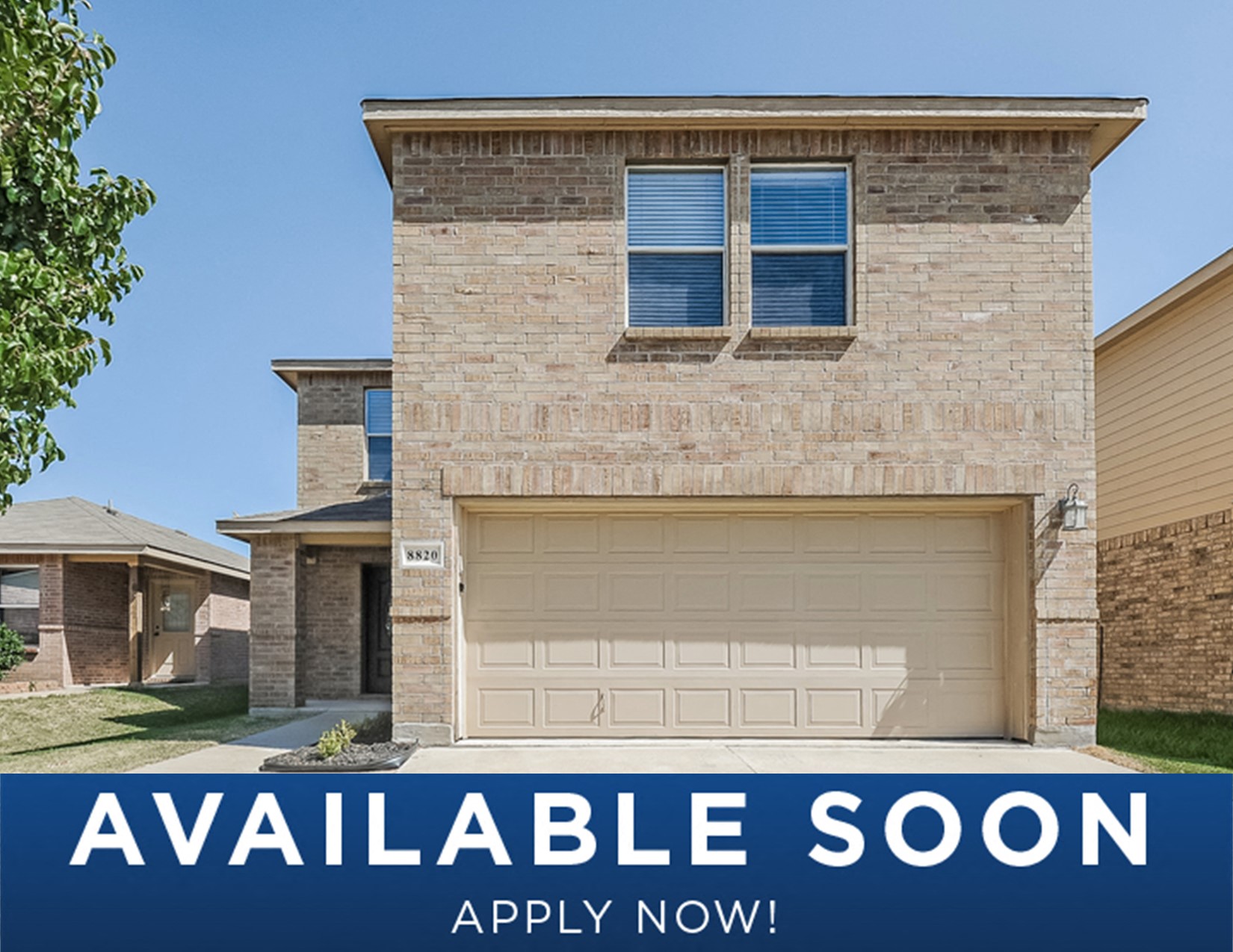 a beige garage door on a brick house with the words affordable soon on it