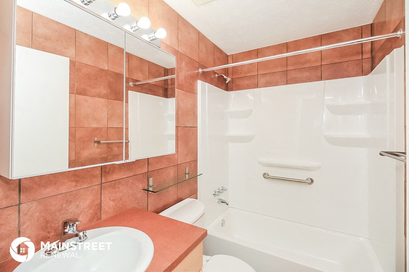 a bathroom with a shower and a sink and a toilet