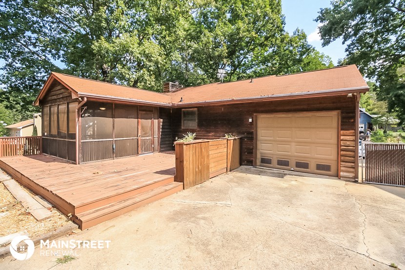 a house with a wooden deck and a garage