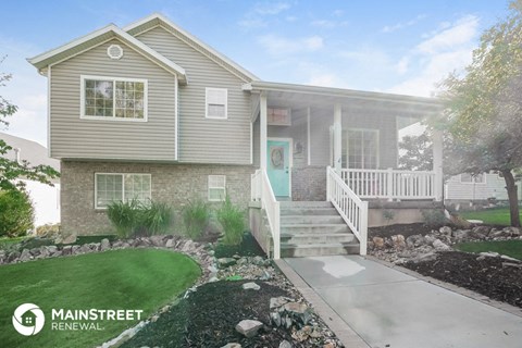 a home with a front porch and steps to a sidewalk